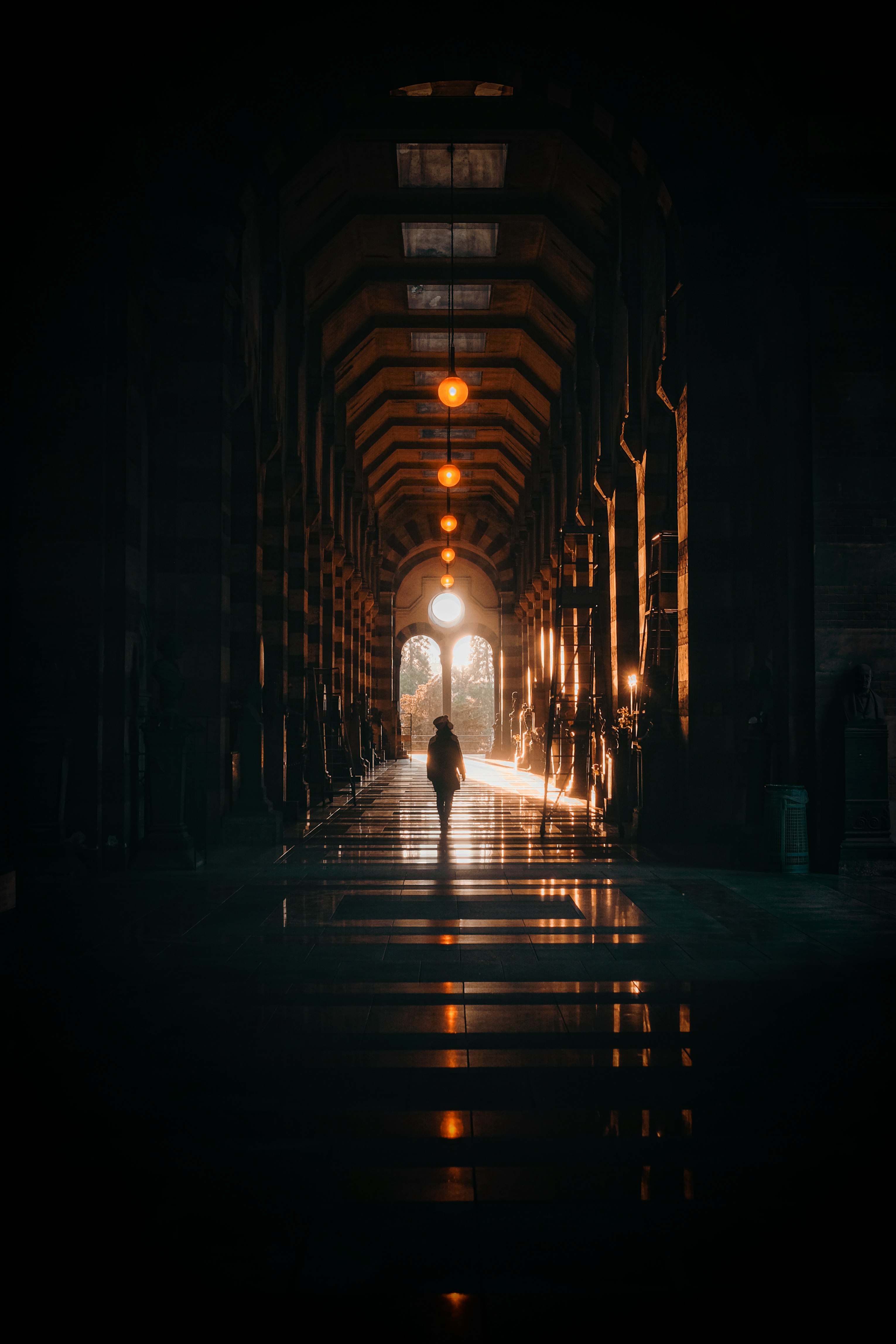 man walking on street during night time